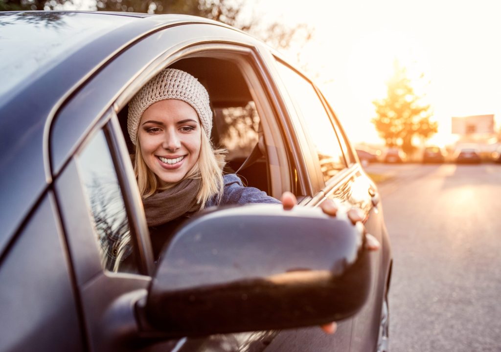 Beautiful young blond woman driving a car